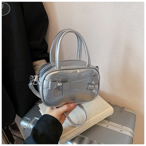 Detailed macro of a metallic silver mini bowling bag with a decorative bow buckle