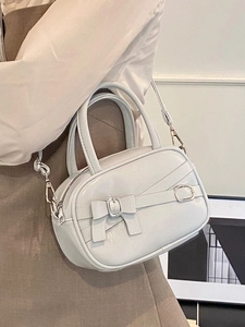 Chic light gray mini bowling bag with bow detail and metallic faux leather finish