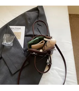 Interior view of the dark brown shell bag showing capacity for phone, wallet and umbrella