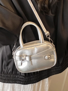 Metallic silver Y2K bowling handbag with bow detail and adjustable shoulder strap