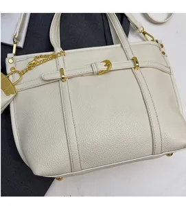 Detail of white lychee pattern leather tote bag with gold hardware and bottom studs