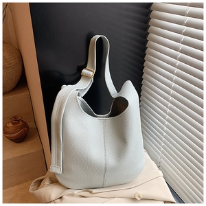 Close-up of mint green lychee grain leather tote bag with elegant golden hardware
