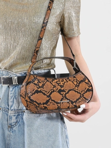 Brown snakeskin pattern crescent bag with dual straps for shoulder or crossbody wear