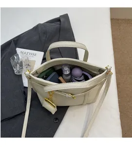 Spacious interior of lychee texture cream tote bag holding umbrella and phone