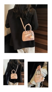 Pink woven texture shell bag with heart charm and detachable shoulder strap detail