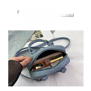 Internal view of the denim bowling bag showing ample storage space for daily essentials