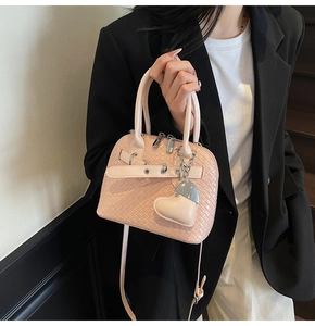 Pink woven texture shell bag with adjustable strap and heart-shaped leather pendant