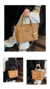 Close-up of brown litchi pattern leather tote bag with adjustable strap and mini charm