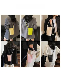 Vertical mini crossbody phone bag shown on models in yellow, green, white, pink and black