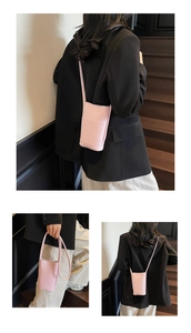 Detail view of a pink litchi textured PU leather mini crossbody phone bag for women