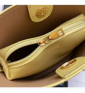 Close-up of litchi pattern bucket bag interior with smooth zipper and magnetic closure