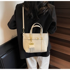 Litchi texture beige handbag with gold metal accents and matching mini pouch charm
