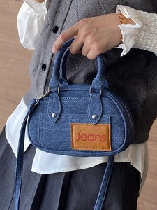Blue denim mini bowling bag with leather patch and adjustable strap for women
