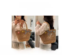 Detail of woven straw tote bag with colorful 3D flowers and checkered ribbon bow