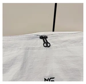 Close-up of smooth double metal zippers and NG embroidery on white nylon tote bag
