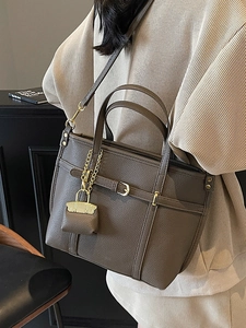 Deep brown lychee pattern leather tote bag with gold hardware and charm detail