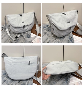 Detail views of light grey nylon messenger bag with MS logo and anti-theft back pocket
