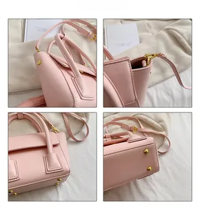 Détails du sac seau en cuir rose avec ferrures dorées et picots de protection en métal