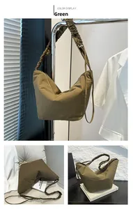 Detailed close-up of army green pleated shoulder strap on a nylon dumpling bag for women