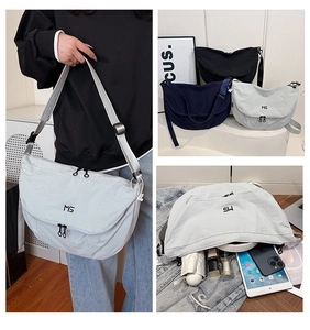 Detail view of lightweight nylon crossbody bag showing large capacity for iPad and items