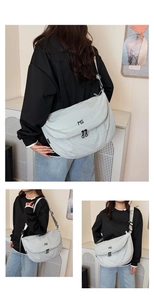 Detail view of the light grey nylon messenger bag with double zippers and MS logo