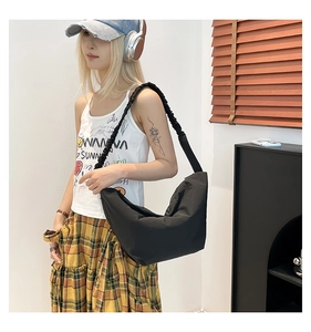 Detail shot of black slouchy hobo bag with unique ruched shoulder strap design