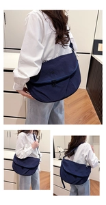 Detailed views of navy blue nylon crossbody bag with adjustable strap and MS logo