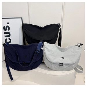 Nylon crescent crossbody bags shown in black, navy, and grey with adjustable straps