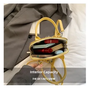Interior view showing large capacity for phone and cosmetics in yellow leather bag