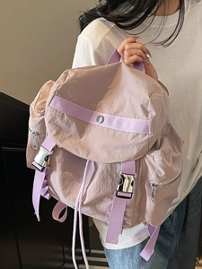 Minimalist light purple nylon backpack for women featuring flap cover and metal buckle
