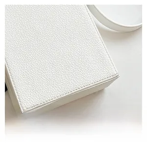 Macro shot of high-quality white litchi grain leather texture and fine stitching detail