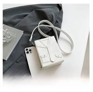 Detail view of white suit-style crossbody bag with leather tie detail and litchi texture