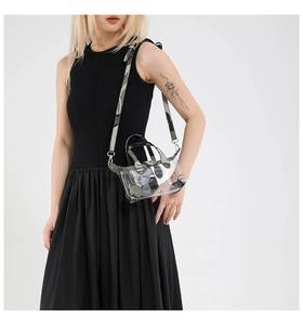 Detailansicht einer transparenten PVC-Minitasche mit Camouflage-Besatz und Gurt