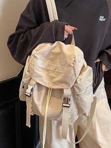 Chic beige nylon backpack with large flap and metal buckles for casual travel and commute