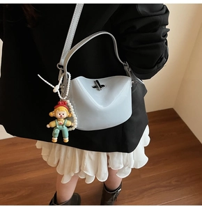 Light blue minimalist tote with glossy finish and cute cartoon charm detail