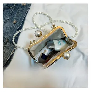 Top view of open blue embroidery clutch showing space for sunscreen and serums