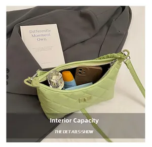 Internal view of green quilted shoulder bag showing capacity for phone and perfume