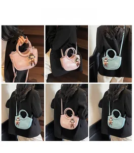 Detail of pink and blue bucket bags featuring pearl handles and cute charms