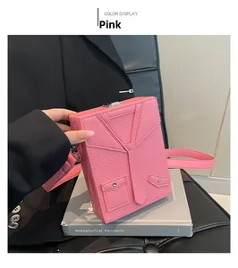 Detail view of pink dopamine suit-style box bag with tuxedo design and leather texture