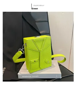 Detailed view of green box bag featuring suit lapel design and silver metal clasp