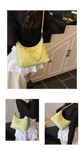 Detail of lime green quilted crescent shoulder bag with chain strap and twist lock