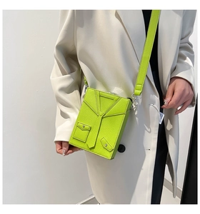 Close-up of neon green box bag with unique necktie design and pebble leather texture