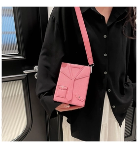Detailed view of pink creative box bag with suit-style design and lychee leather texture