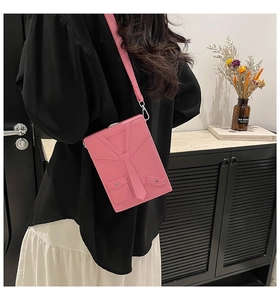 Detail of pink suit-style box bag with lychee grain texture and miniature decorative tie