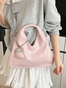 Pink patent leather triangle handbag with pleated texture and silver chain strap