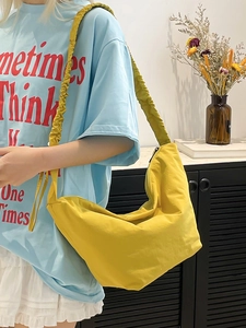 Minimalist bright yellow hobo bag with stylish ruched strap for daily versatile commuting