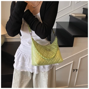 Detailed texture of lime green quilted leather shoulder bag with chic chain strap