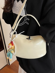 Creamy oil wax leather handbag with cute cartoon charm and pearl chain detail