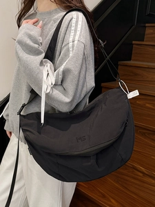 Versatile black nylon crescent tote bag with MS logo for daily travel and commute