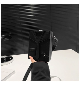 Detail of a black suit jacket shaped box bag with silver studs and荔枝 pattern leather